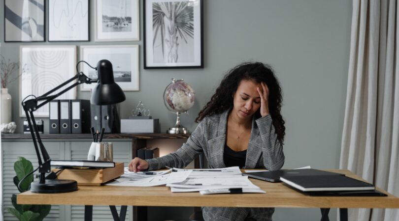 stressed woman at desk representing hidden anxiety